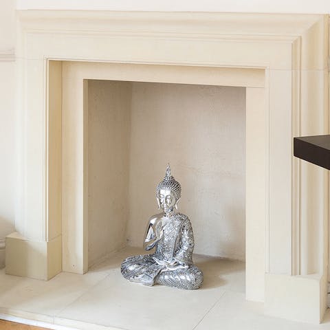 A silver buddha in the fireplace