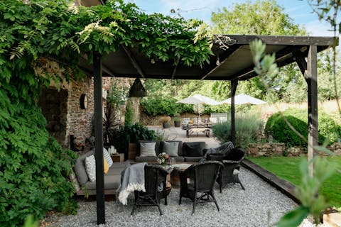 Unwind with a glass of wine under the ivy-covered pergola