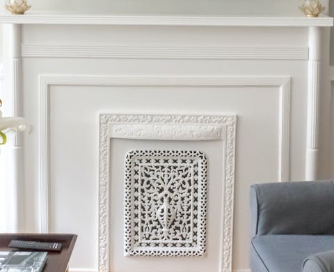 Curl up around the original ornate fireplace