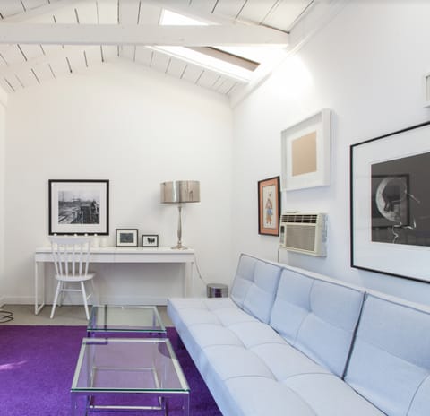 A purple carpeted, arched ceiling study