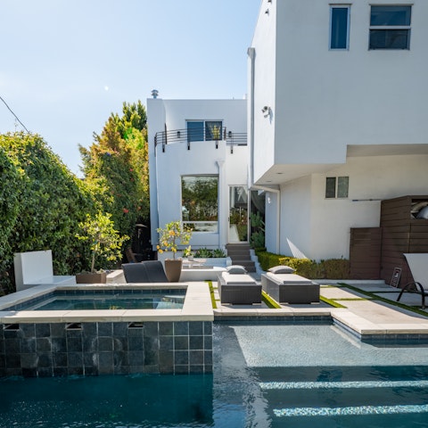 Lounge by the pool or soak in the Jacuzzi on the sun-kissed back patio