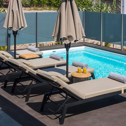 Sunbathe on the day beds while soaking up the Mediterranean views