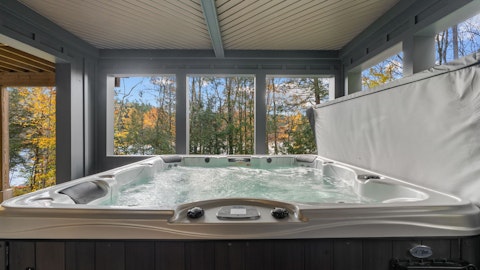 Soak in the hot tub as autumn colours frame the treeline