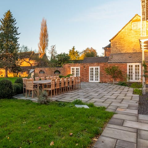 Dine on the home's terrace while the sun sets overhead
