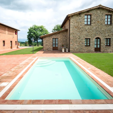 Go for a swim in one of the communal swimming pools overlooking rural Tuscany