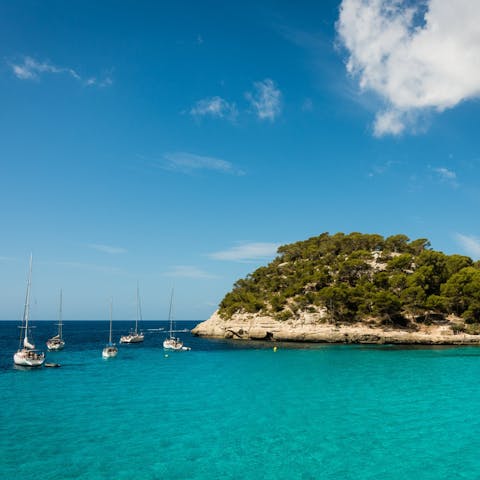 Head out and explore the beautiful bay of Arenal d'en Castel, just a short drive from your villa