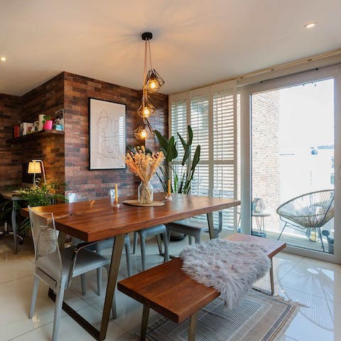 Sit down to a meal at the chic bench table before enjoying a nightcap on the balcony