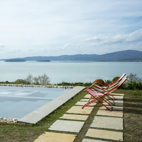Lay poolside with serene views over lake Trasimeno