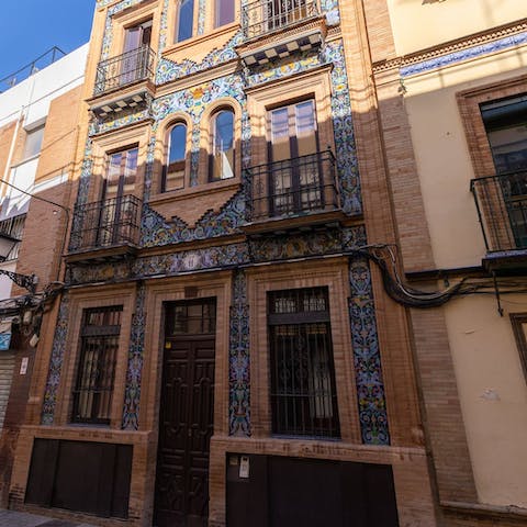 Admire the Spanish ceramic tiles on this building's facade