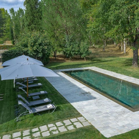 Relax by the pool on a warm Tuscan afternoon