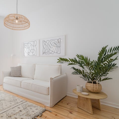 Sink into your plush sofa surrounded by rattan furnishings and tropical plants