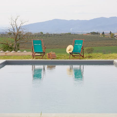 Admire the rolling Tuscan hills from the comfort of the poolside