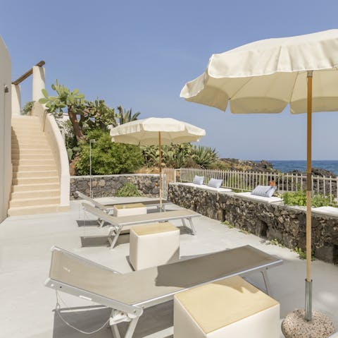 Lie back and relax with a book on plush sunloungers