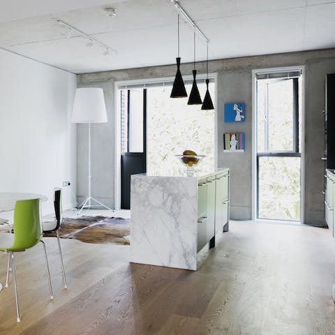Prepare a sumptuous meal on the marble worktop by the huge windows