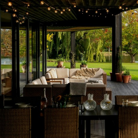 Dine alfresco as evening light falls across the lake