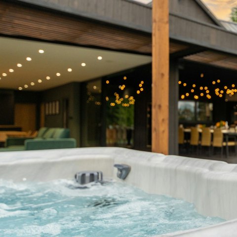 Savour a glass of fizz while enjoying a soak in the hot tub