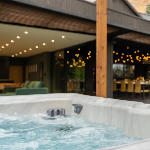 Savour a glass of fizz while enjoying a soak in the hot tub
