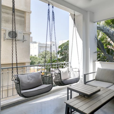 Relax in the swing chairs with a glass of wine in the evening