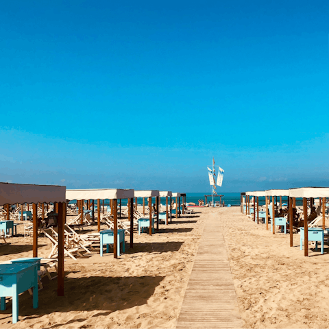 Sprawl out on Viareggio's sandy beach, 10km away