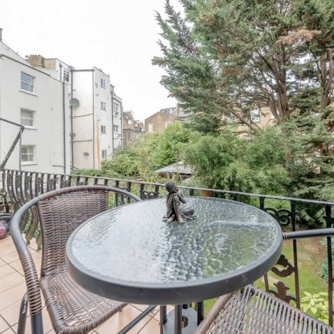 Enjoy coffee or a cocktail on the private balcony