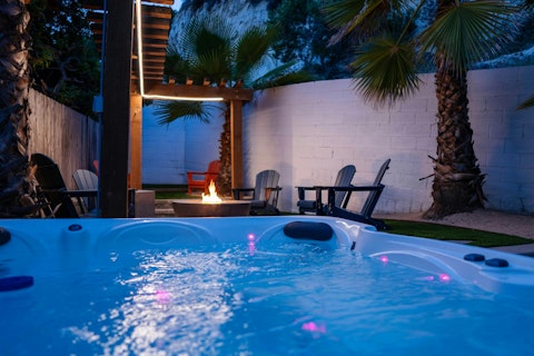 Step into the hot tub as the fire pit glows
