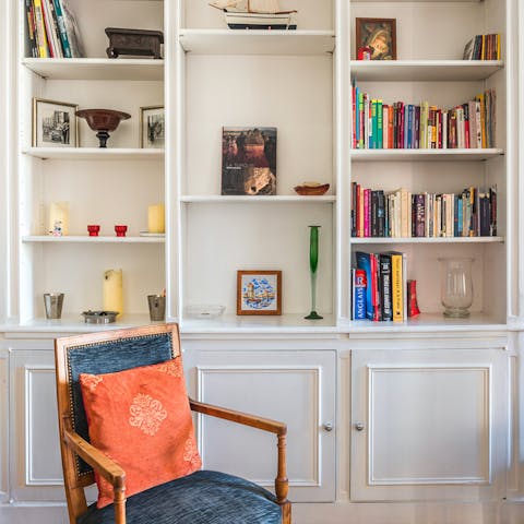 A dresser full of trinkets and books