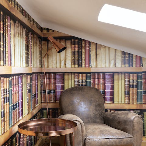 Read in the charming nook with book-lined wallpaper