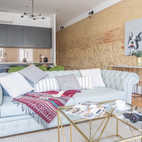 Sink into the chesterfield sofa in a rustic living room full of character