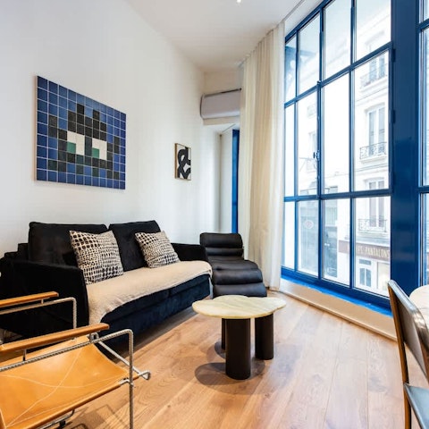 Curl up with coffees and watch Sentier bustle below