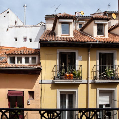 Open the glass door in one of the bedrooms and look out over the balcony to a view of La Latina