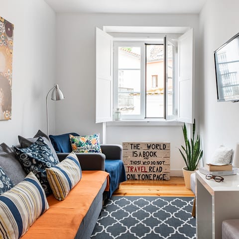Kick back and relax in the luminous living room after a day exploring Lisbon's seven hills on foot