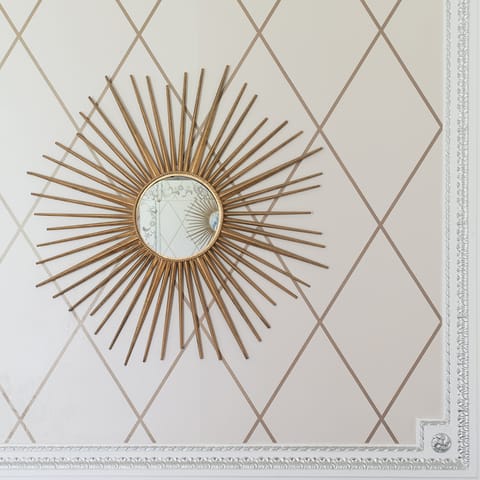 The gold-framed mirror