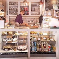 Shop pillows and postcards while eating cake at Café Eliza