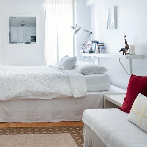 Unwind on the plush, white bedding after a day's excursions in NYC