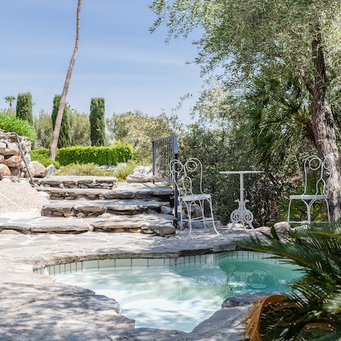 Relax in the grotto-like hot tub with waterfall