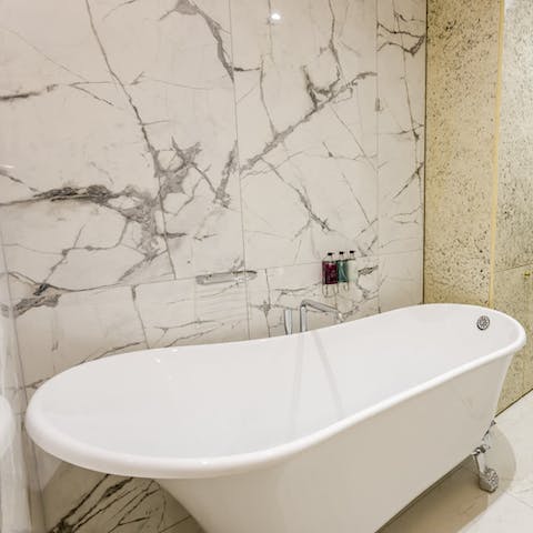 Have a long soak in the marble-clad bathroom's clawfoot tub