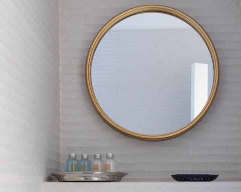 The gorgeous brass mirror in the bathroom