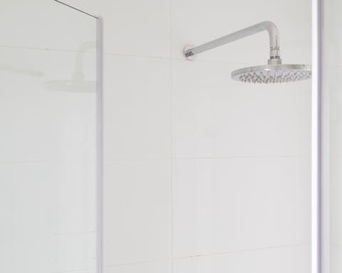 A bathroom with a rainfall shower