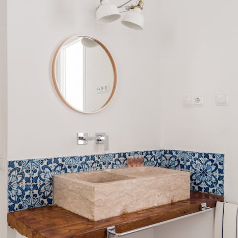 The traditional azulejo tiles behind this sink