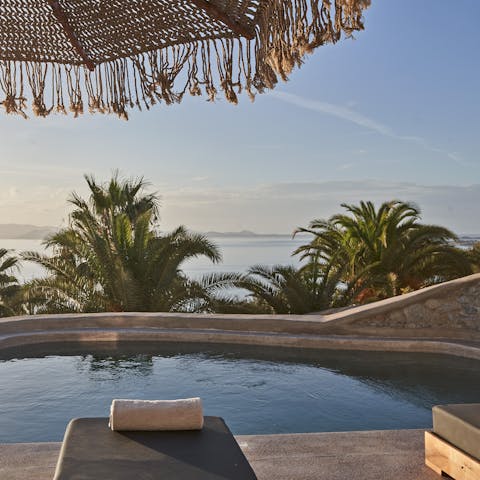 Enjoy idyllic island views while relaxing by the pool