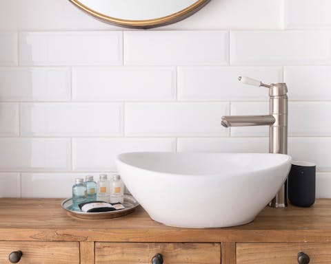 Glossy metro tiling in both bathrooms