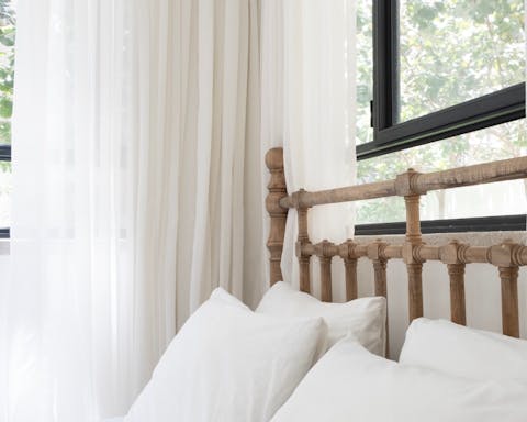 The wooden bed frame with handcarved details