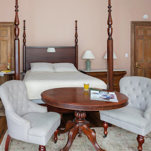 The tufted armchairs and mahogany table