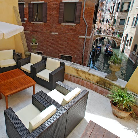Enjoy the view of the canal as you sip a negroni on the communal terrace