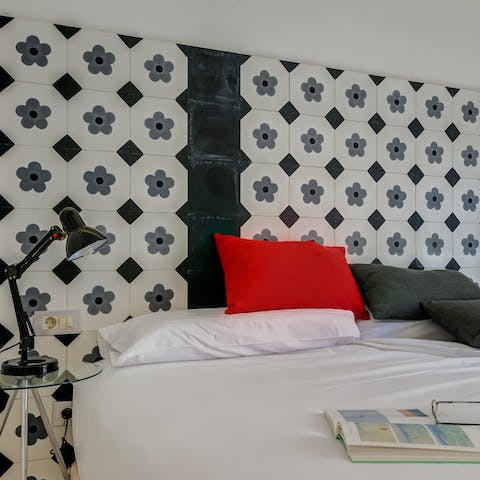 Lay back in comfort beneath the azulejo-inspired headboard