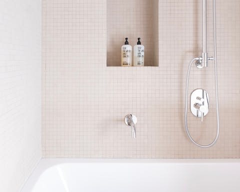 The sleek cream-coloured bathroom