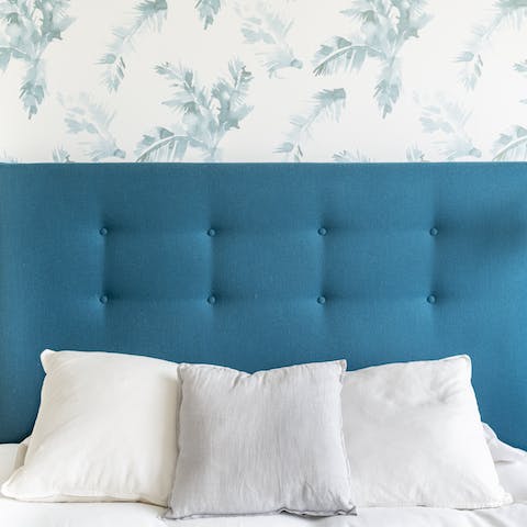 The soft teal headboard