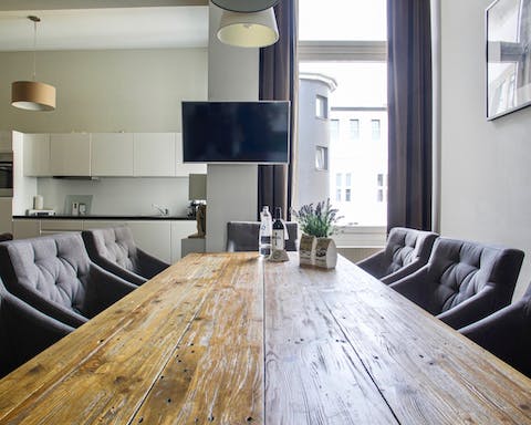 Gather around the large wooden table for an aperitif after a day of exploring Berlin