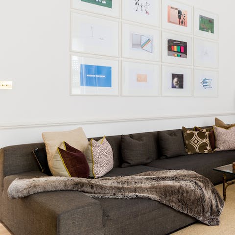 Sink into the large sofa in an elegant and artistic living space