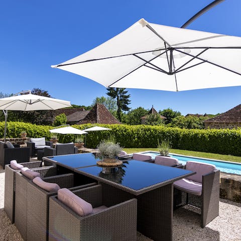 Enjoy alfresco meals overlooking the pool